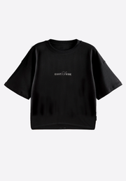 Oversized cropped black T-shirt on plain background – East Vibe
