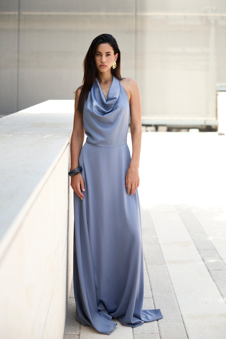 Woman wearing a long light blue dress in an indoor setting
