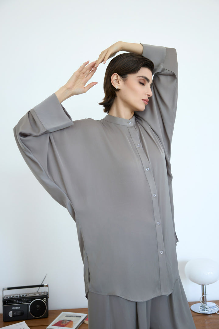 Woman wearing a gray outfit with a white background