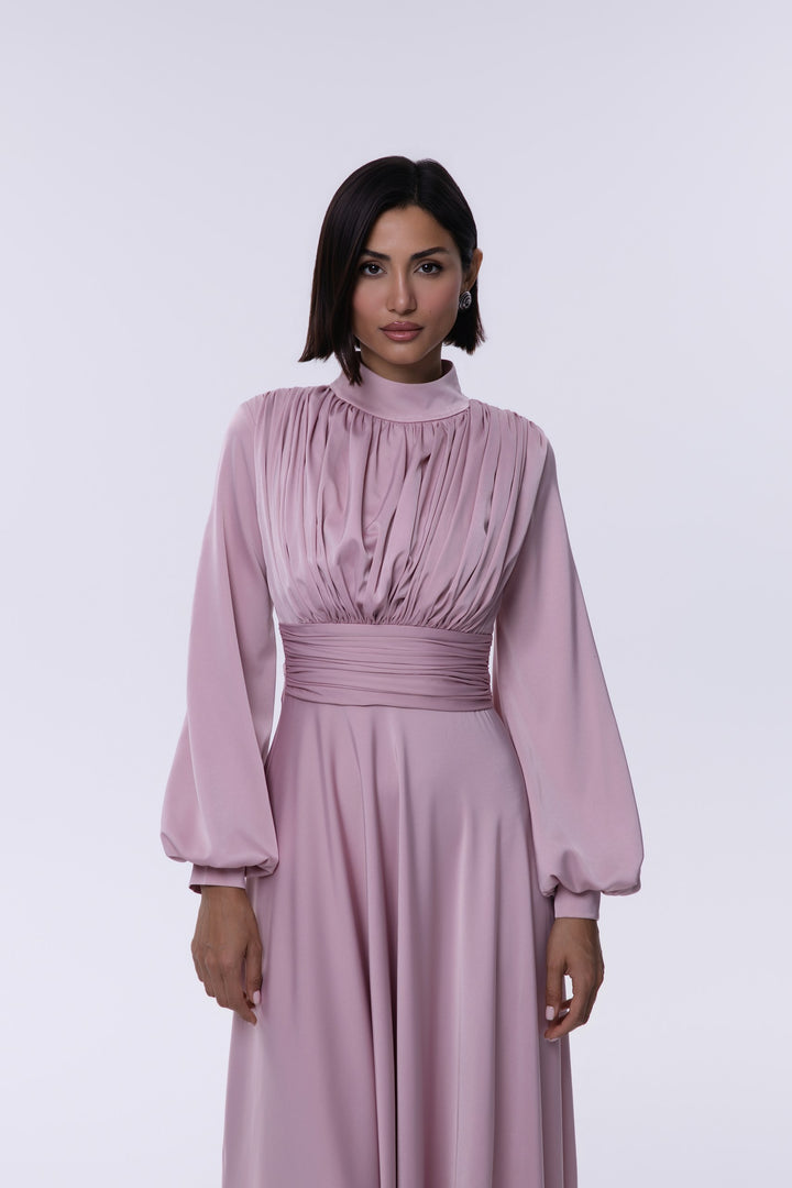 Woman wearing a pink dress against a white background