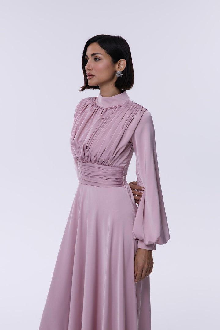 Woman wearing a pink dress against a white background