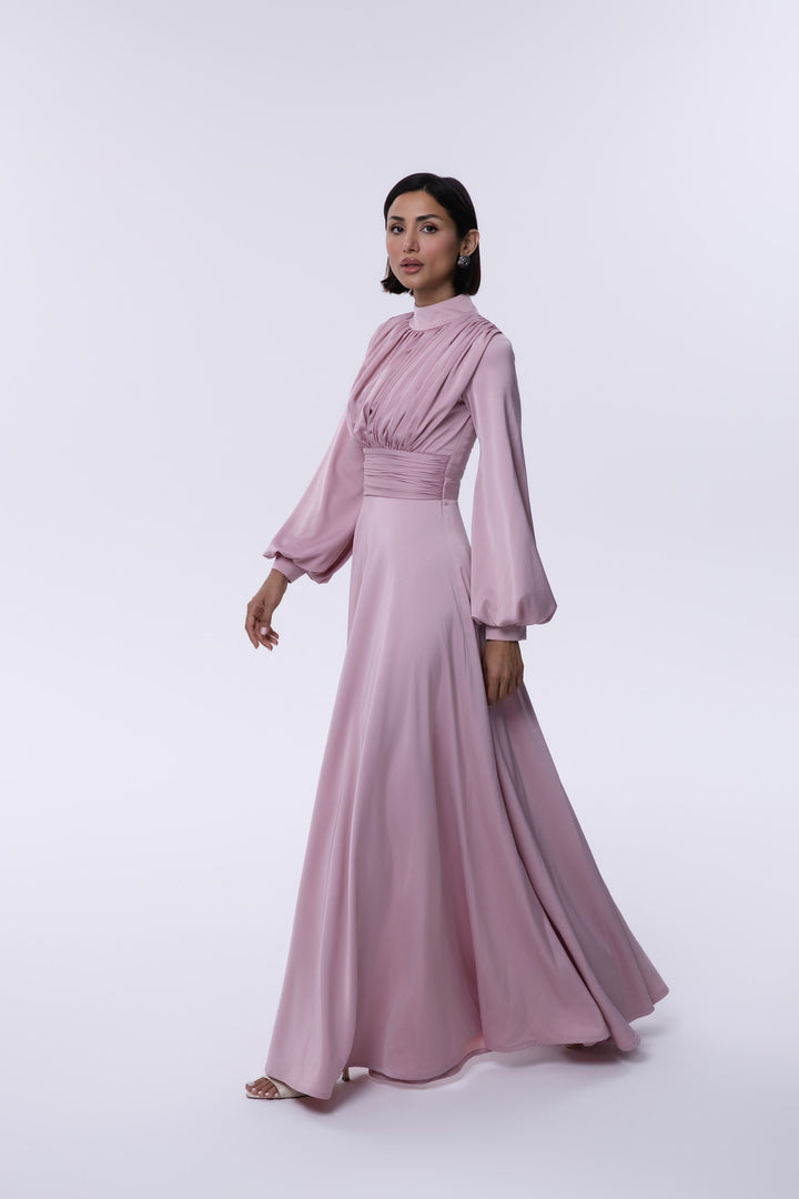Woman wearing a pink dress on a white background