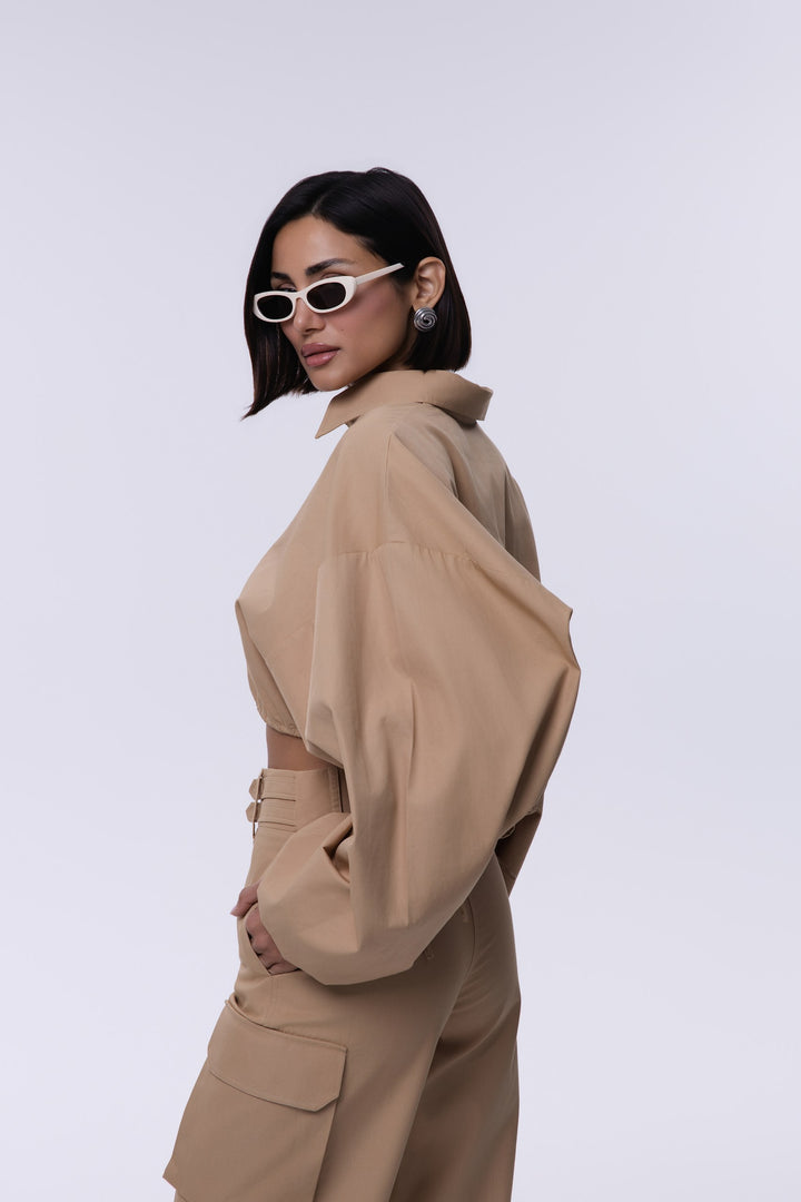 Woman wearing a beige trench coat on a white background