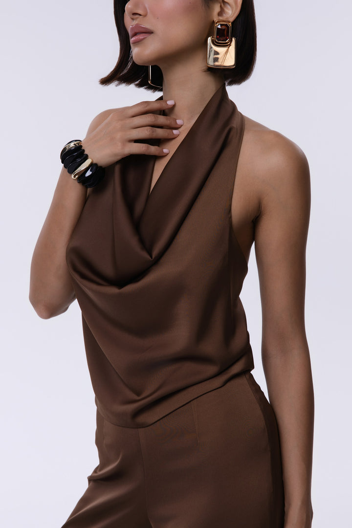 Woman wearing a brown dress with a plain background