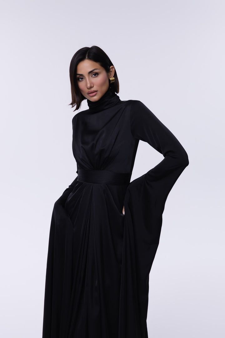 Woman wearing a black dress against a white background