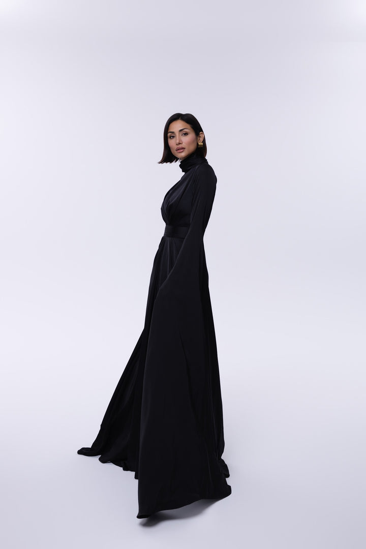 Woman wearing a black dress against a white background
