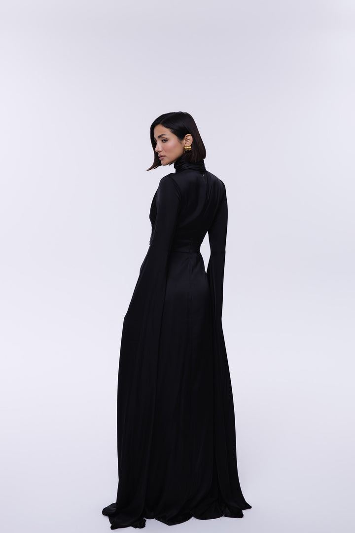 Woman wearing a long black dress on a white background