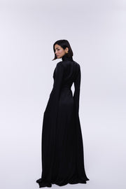 Woman wearing a long black dress on a white background
