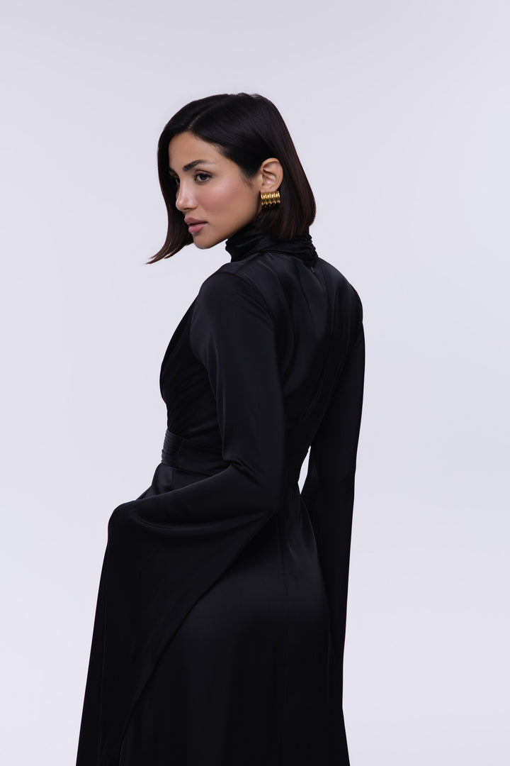 Woman wearing a black dress against a white background