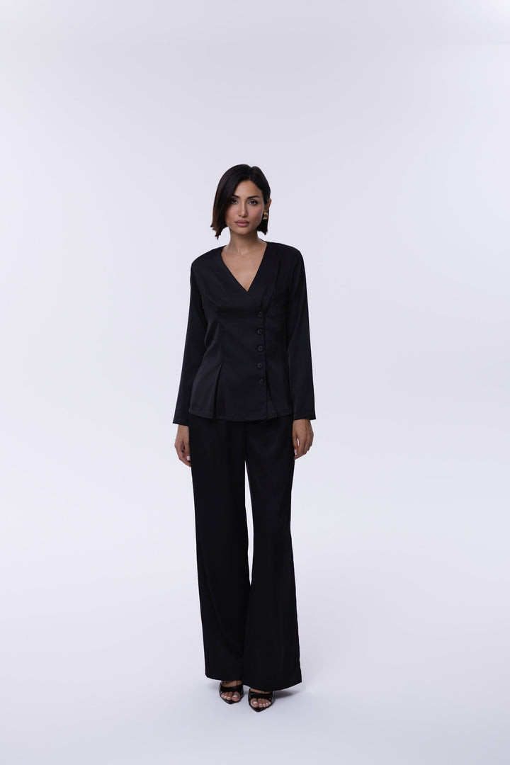 Woman wearing a black suit on a white background