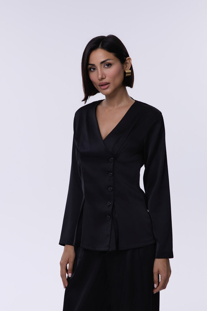 Woman wearing a black outfit against a white background