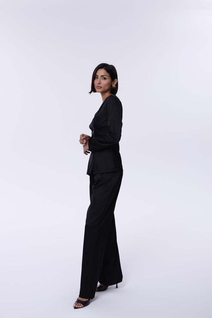 Woman wearing a black outfit on a white background