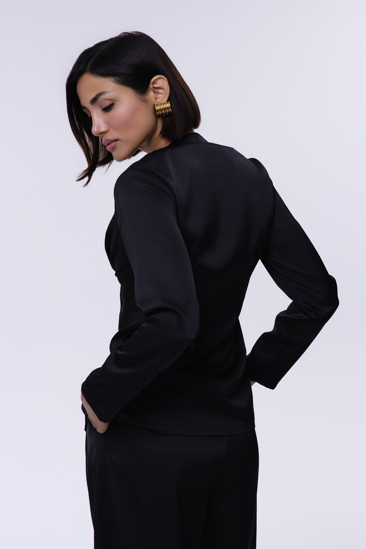Woman wearing a black outfit against a white background