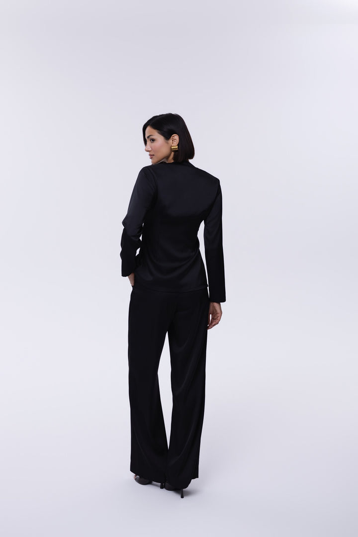 Person wearing a black outfit on a white background