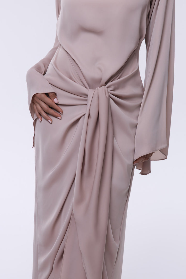Mauve long-sleeve dress with a knot detail on a white background