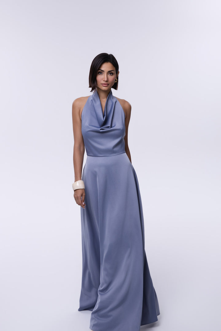 Woman wearing a light blue dress against a white background