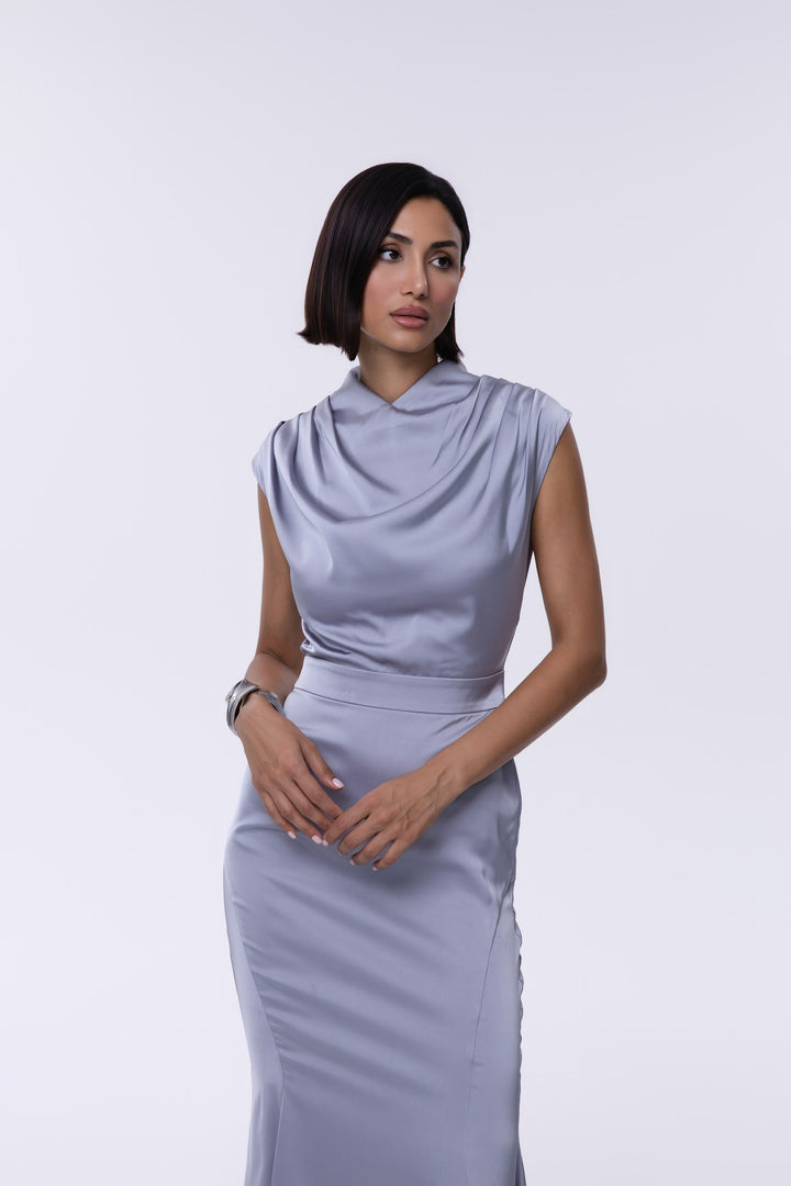 Woman wearing a light purple dress against a white background