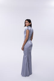 Woman wearing a light blue sleeveless dress on a white background