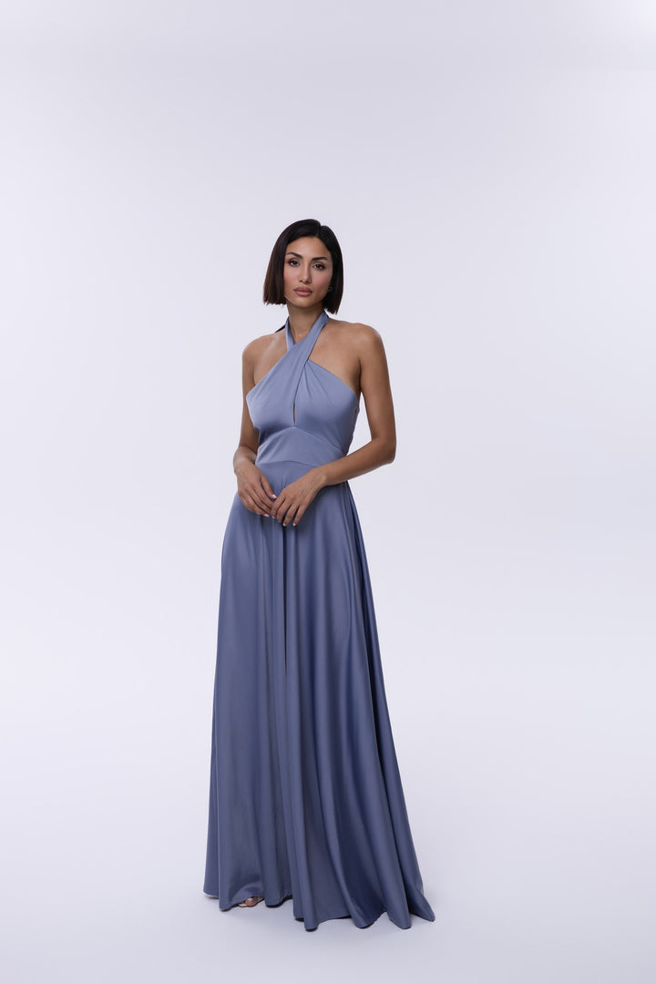 Woman wearing a long blue dress on a white background