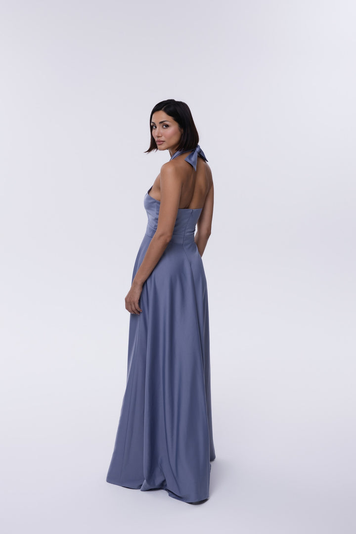 Woman wearing a long blue dress on a white background