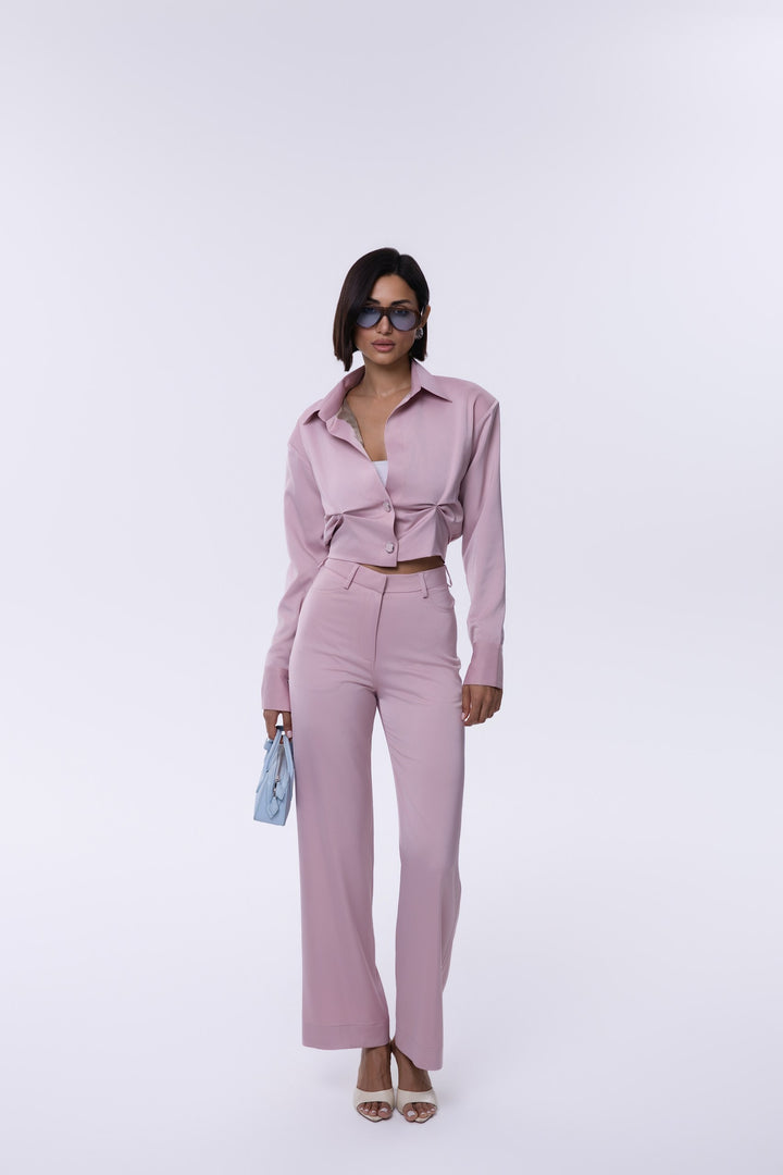 Woman wearing a pink outfit with a white background