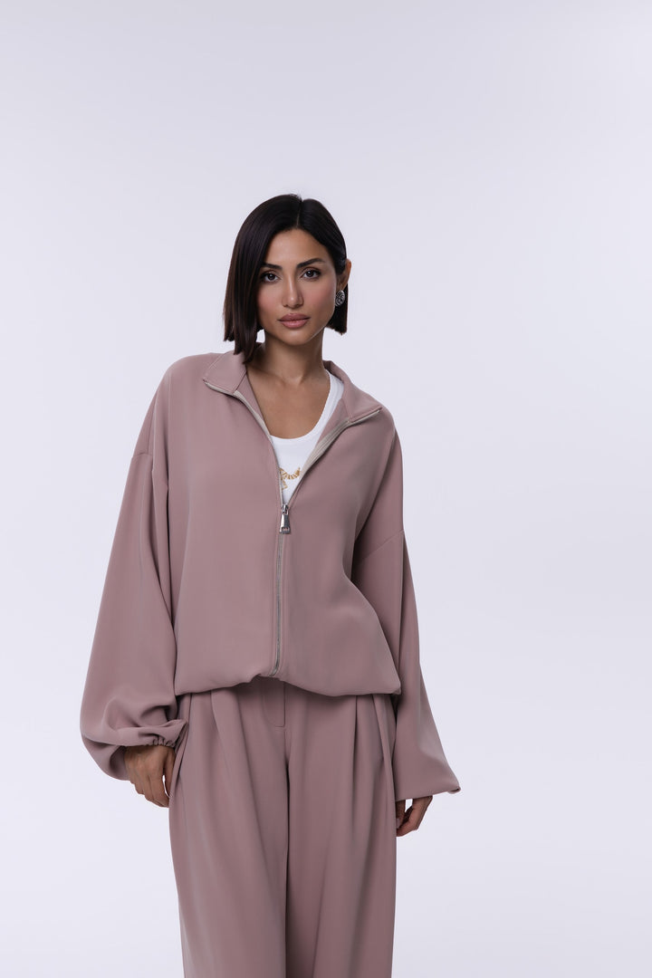 Woman wearing a mauve outfit on a white background