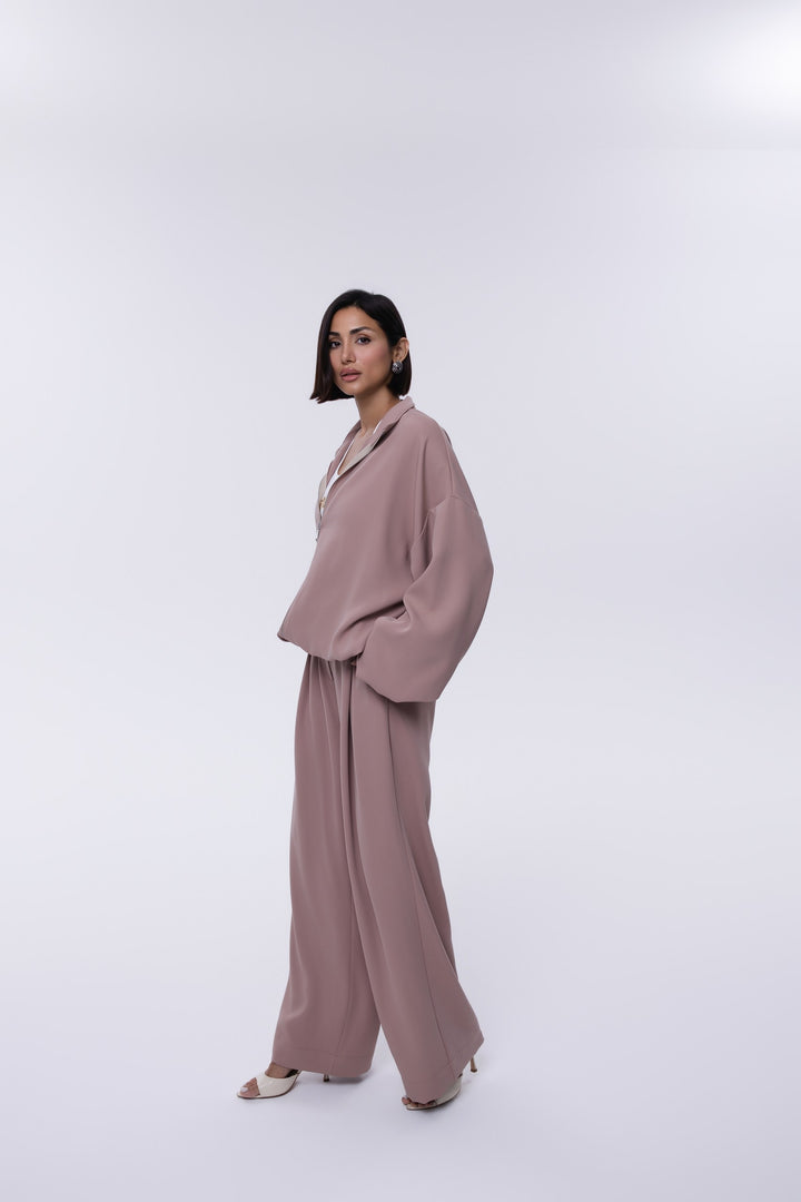 Woman wearing a mauve suit on a white background