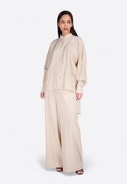 Model wearing tailored beige cotton trousers, clear front view – East Vibe
