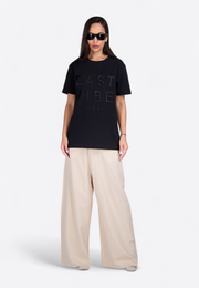 Full front view of model wearing 3D embroidered black T-shirt, East Vibe