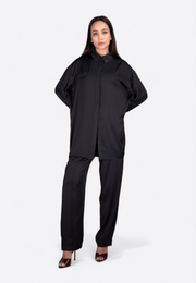 Model wearing full formal outfit including black trousers by East Vibe 