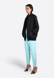 Side view of hooded black zip-up jacket on model, East Vibe
