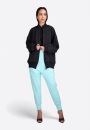 Model wearing front view of hooded zip-through black jacket, East Vibe
