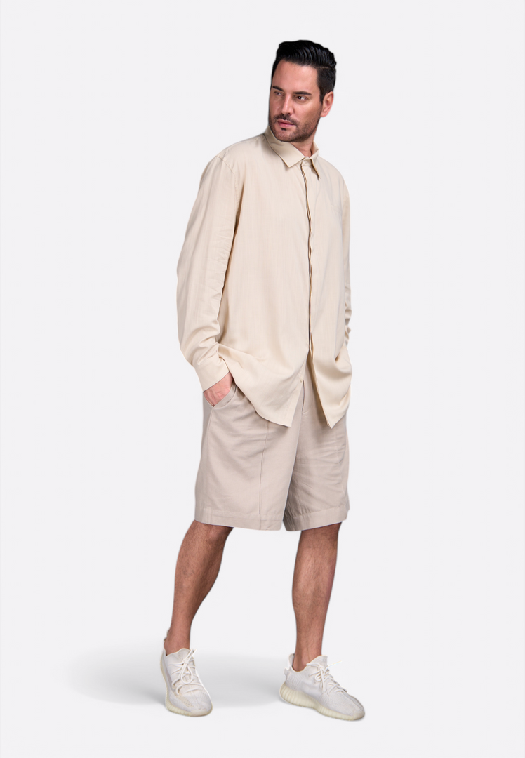 Model wearing beige long sleeve shirt by East Vibe