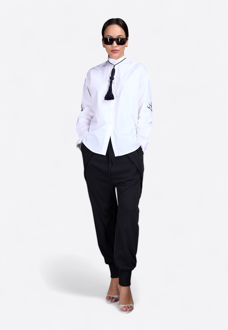 Model wearing classic shirt with decorative tassel, front-side view – East Vibe
