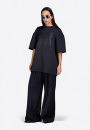 Model wearing Signature “Camel” black cotton T-shirt, full front view – East Vibe
