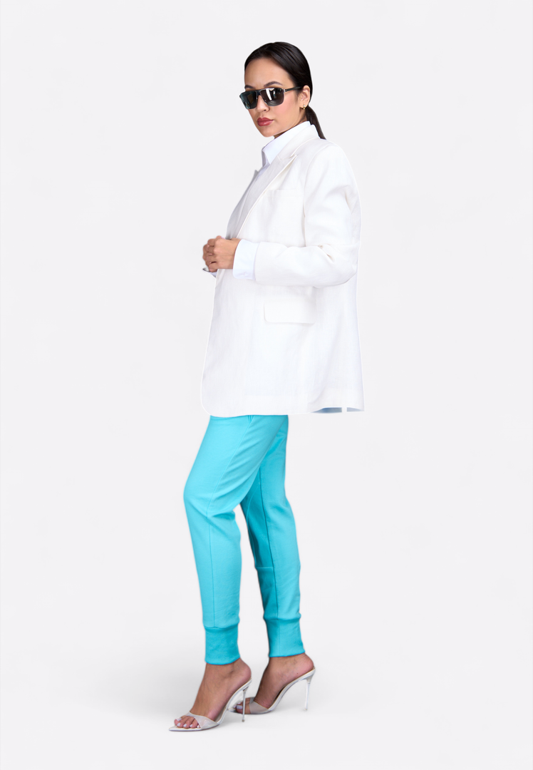 Model wearing tailored white linen blazer, side stylish pose – East Vibe
