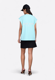 Model wearing Falcon sleeveless Tiffany vest, back view – East Vibe

