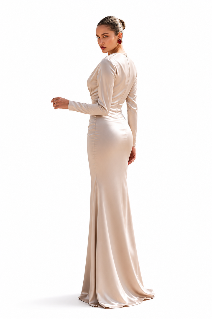 Woman wearing a long beige evening gown on a white background