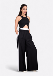 Model wearing black curved hem tank top, East Vibe