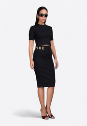 Model wearing monogram slim-fit pencil skirt, front view – East Vibe
