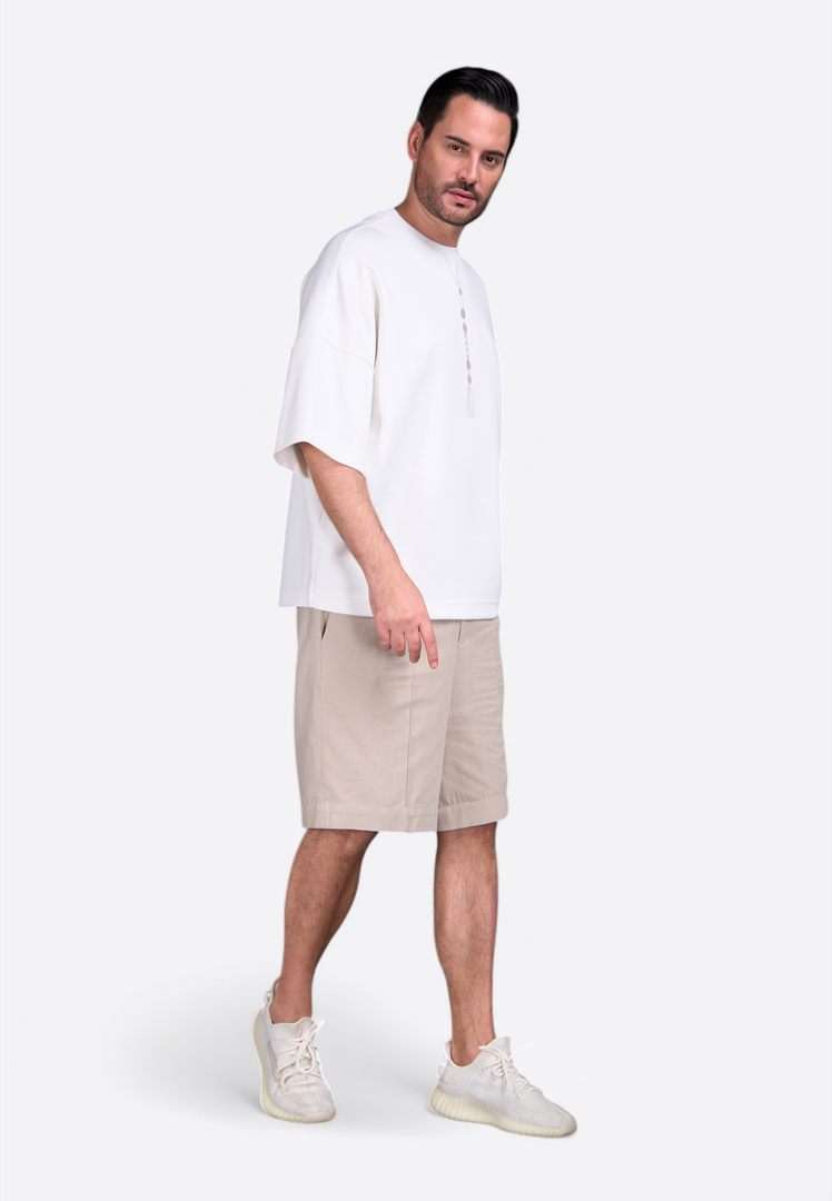Model wearing oversized white T-shirt with tassel by East Vibe