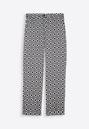 Close-up of printed black trousers on plain background, East Vibe
