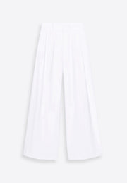 White wide-leg linen trousers on plain background, East Vibe
