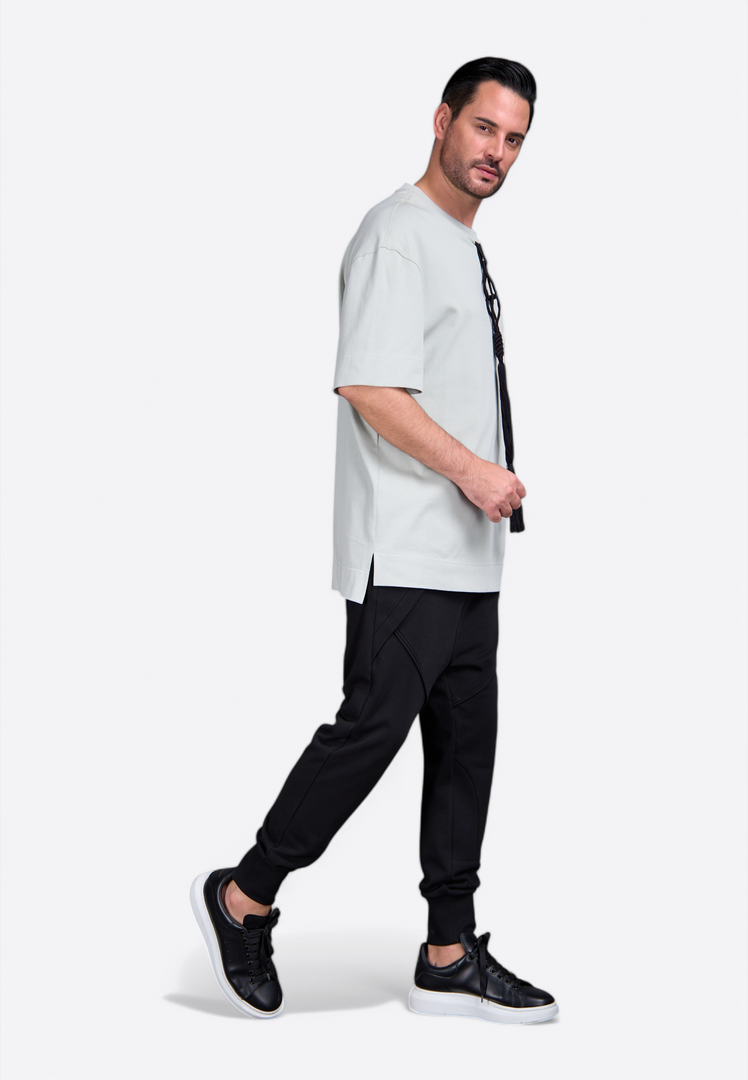 Model wearing Emirates Limited men's t-shirt with tassel by East Vibe