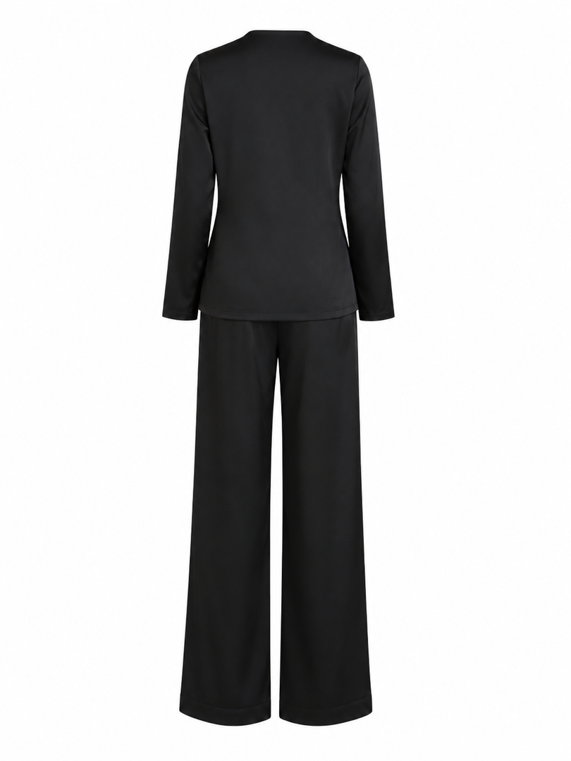 Black outfit with long-sleeve top and wide-leg pants on a white background